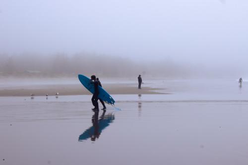 surfers on the beach in crescent city