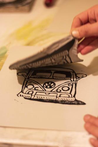 hand picking up a block to reveal vw bus print